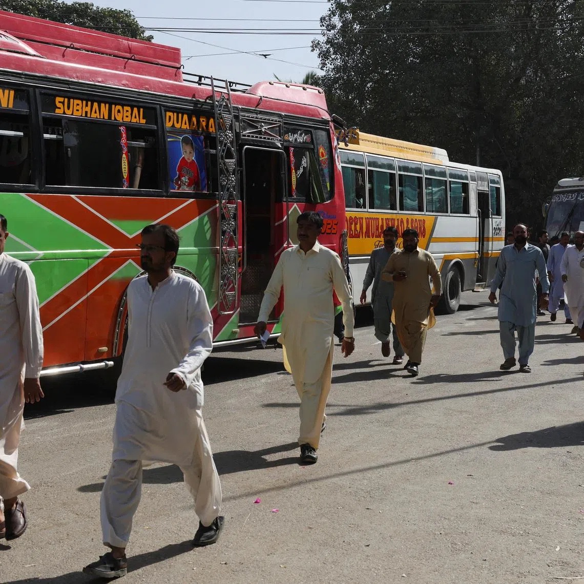 Government employees walk as they arrive to work at the provincial Sindh Secretariat building, after the government announced on March 9 that schools would close for two weeks and only 50% of staff will work in offices, except in essential services, as part of austerity measures to save fuel amid rising oil prices as the closure of the Strait of Hormuz threatens to trigger a severe crisis, amid the U.S.-Israeli conflict with Iran, in Karachi, Pakistan, March 16, 2026. REUTERS/Akhtar Soomro