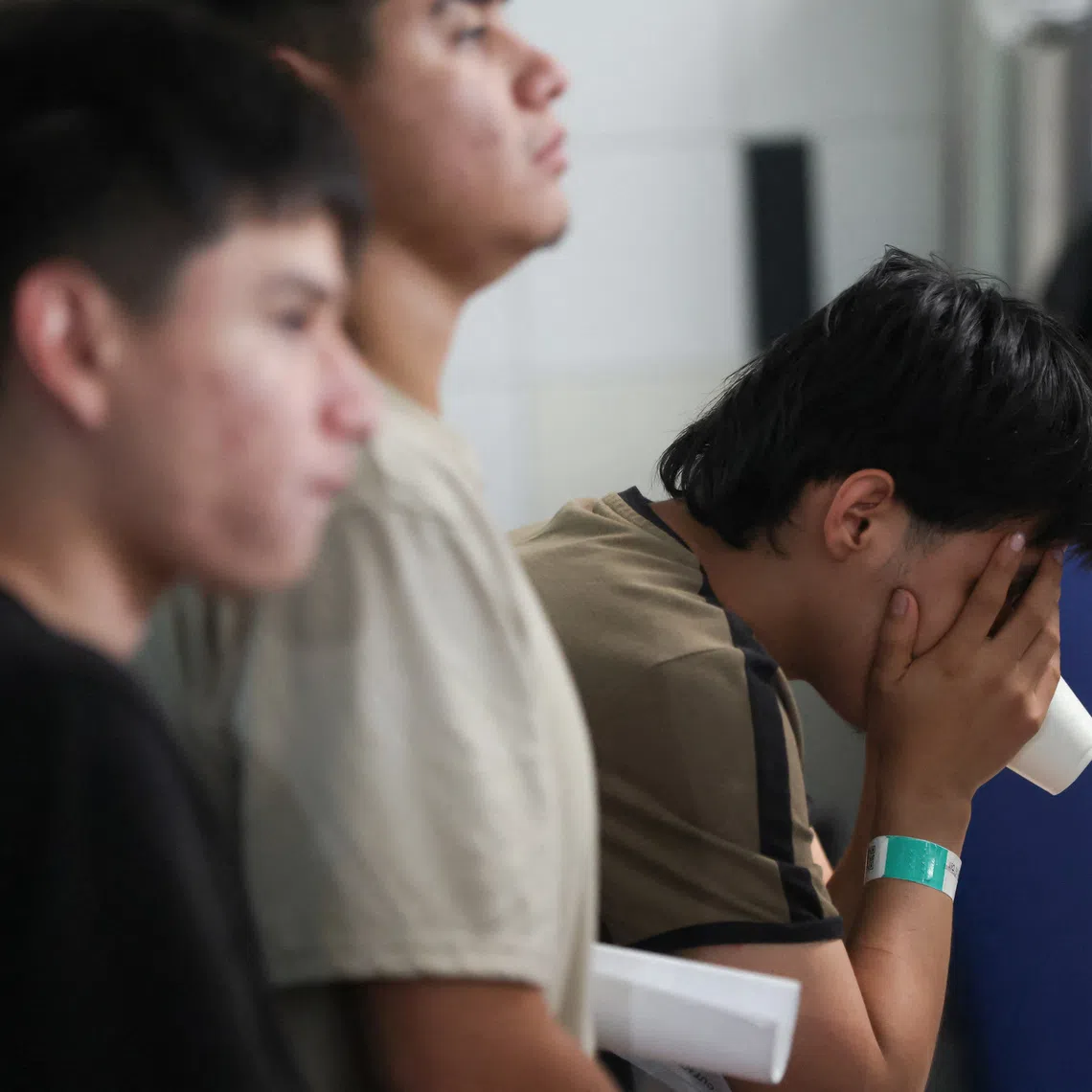 FILE PHOTO: Mexican migrants deported from the United States to Guatemala sit at the Reception Center for Guatemalan Returnees after arriving at La Aurora International Airport in Guatemala City, Guatemala, August 21, 2026. REUTERS/Mariano Macz/File Photo