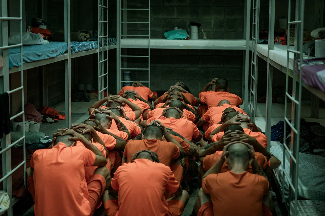 Inmates sit on the floor with their hands on their heads inside a cell following their transfer to the Center for High Containment of Organized Crime (CACCO), a new maximum-security prison built in cooperation with the government of El Salvador President Nayib Bukele, in Alajuela, Costa Rica, in this handout image distributed on October 27, 2026. Ministerio de Justicia y Paz/Handout via REUTERS ATTENTION EDITORS - THIS IMAGE HAS BEEN SUPPLIED BY A THIRD PARTY. NO RESALES. NO ARCHIVES