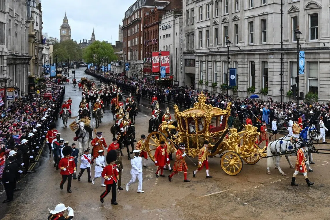 Britain's Queen Camilla and Britain's King Charles III travel in the Gold State Coach, back to Buckingham Palace, in central London, on May 6.