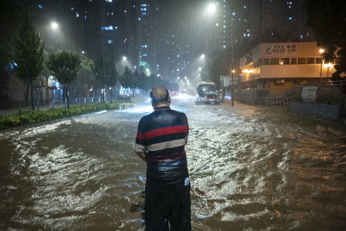 A pedestrian wading through floodwaters during heavy rain in Hong Kong, China, on Sept. 8, 2023. 