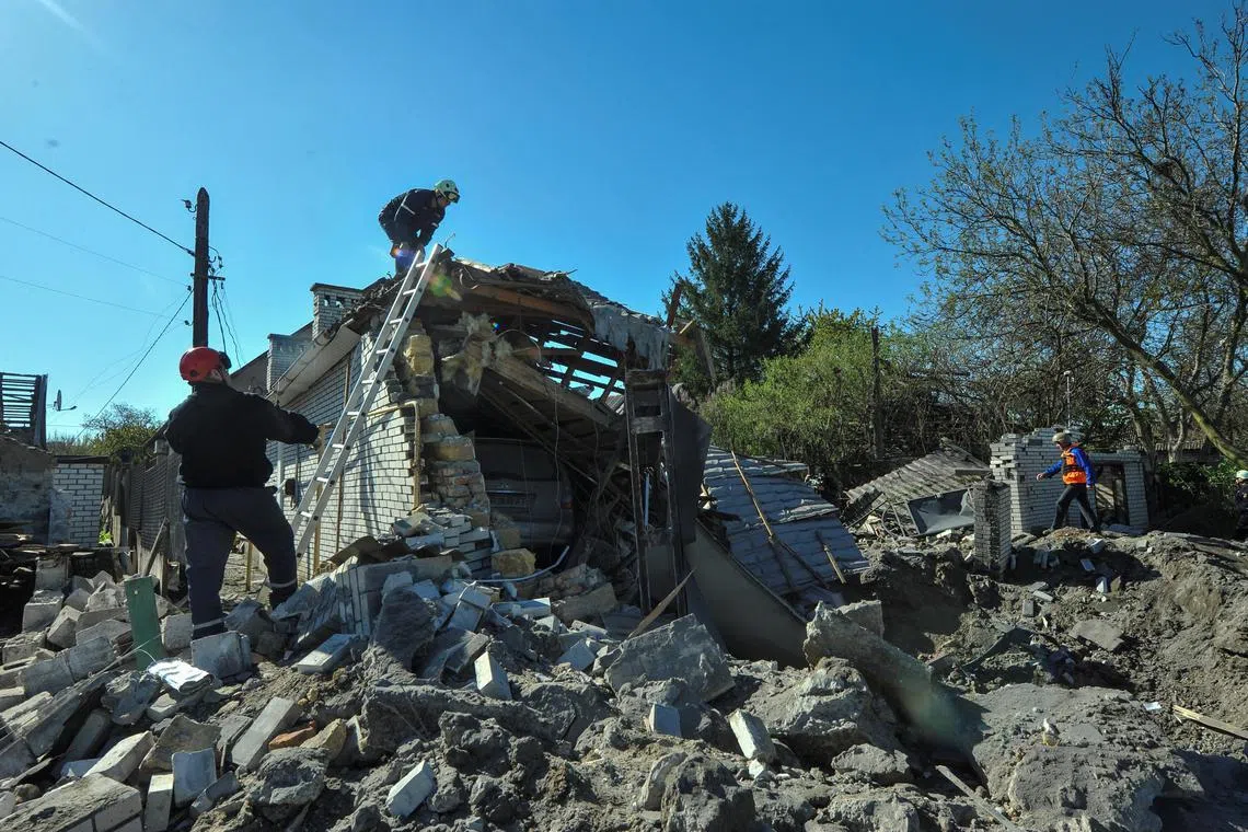 Rescuers work at the site of a residential area heavily damaged by a Russian missile strike in Zaporizhzhia, Ukraine, on May 3. 