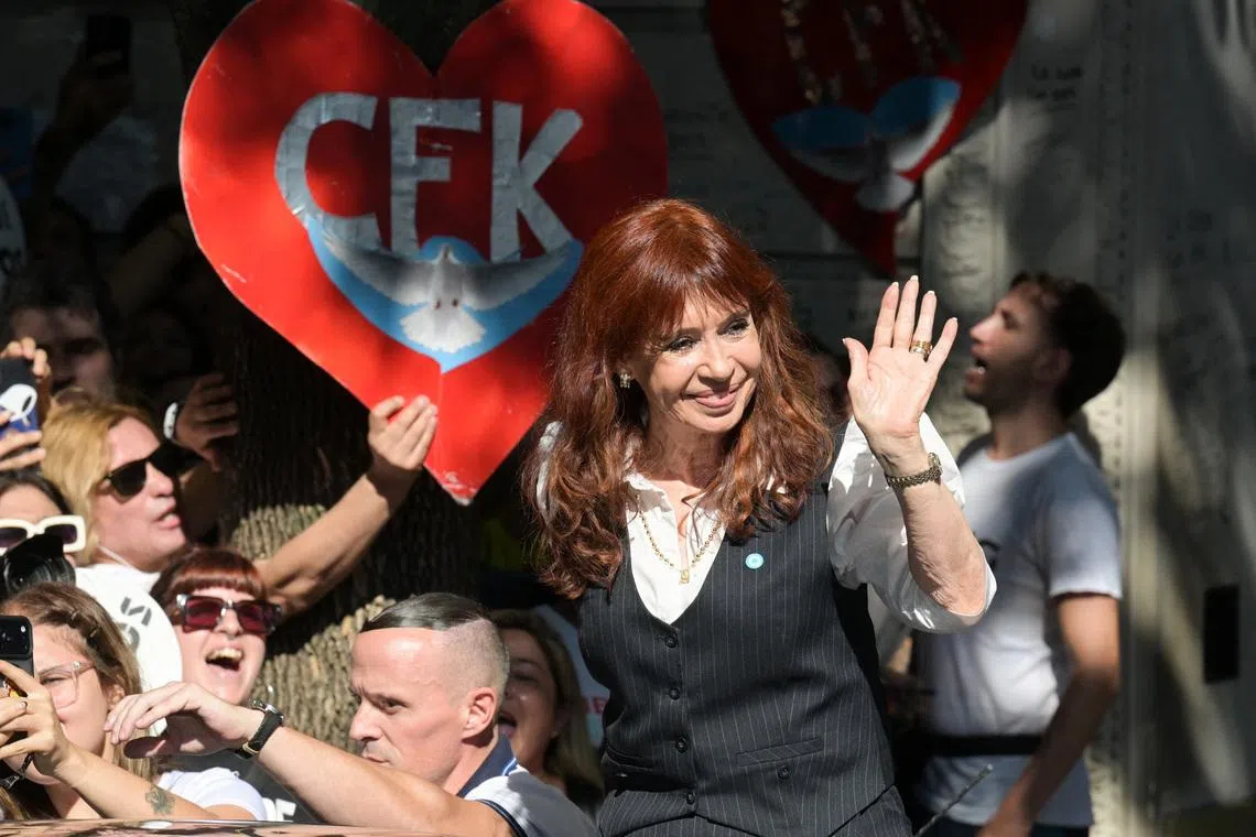 Argentina's former President Cristina Fernandez de Kirchner waves outside her residence, where she is currently staying under house arrest, on the day of a hearing in the \"Causa Cuadernos\" corruption trial, after being summoned to testify following the rejection of defence motions seeking to nullify the proceedings, in Buenos Aires, Argentina, March 17, 2026. REUTERS/Martin Cossarini