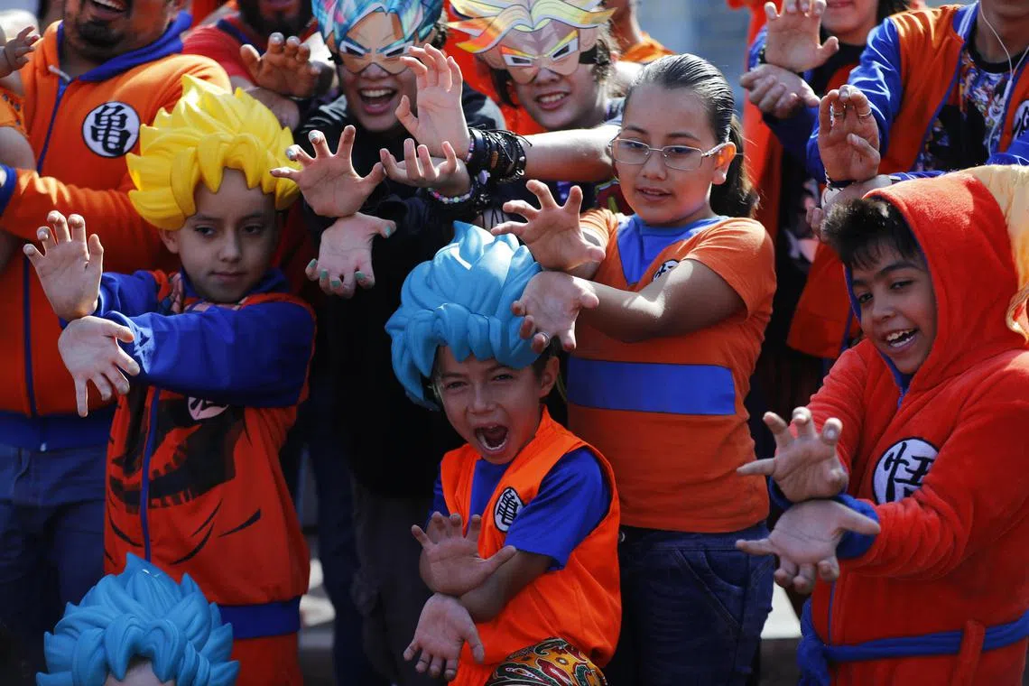 epa11211991 Dragon Ball fans participate in a performance called 'massive Genkidama' at the Minerva roundabout in Guadalajara, Mexico, 10 March 2024. Called through social media, thousands of fans got together to pay tribute to Akira Toriyama, who died on 01 March 2024.  EPA-EFE/FRANCISCO GUASCO