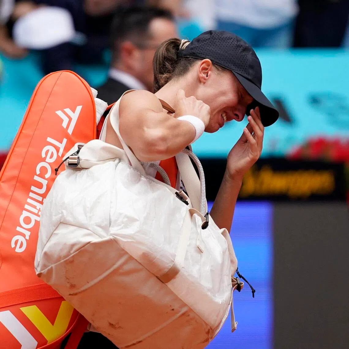 Poland's Iga Swiatek looks dejected after retiring in her round of 32 match against Ann Li of the United States.