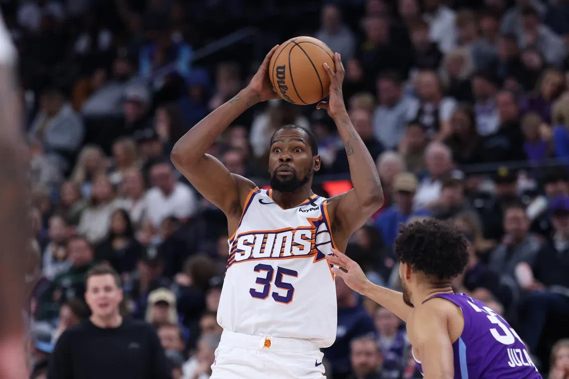 Dec 13, 2024; Salt Lake City, Utah, USA; Phoenix Suns forward Kevin Durant (35) looks to pass the ball against Utah Jazz guard Johnny Juzang (33) during the fourth quarter at Delta Center. Rob Gray-Imagn Images/File Photo