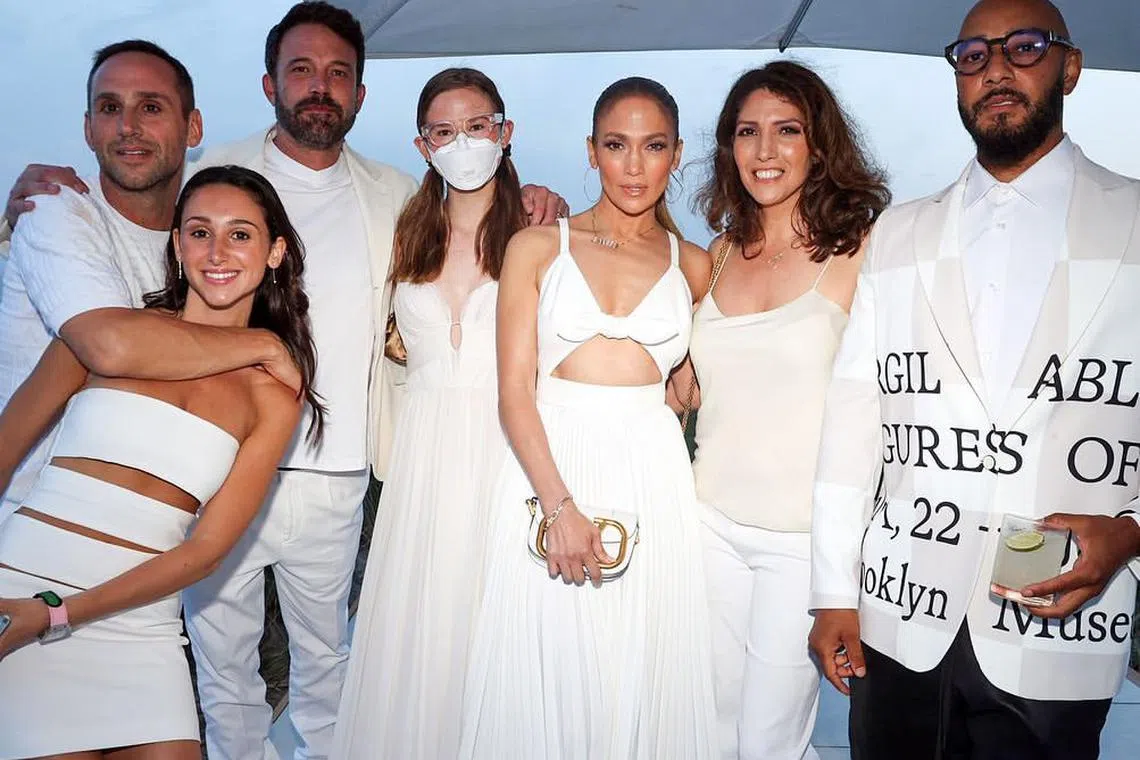 The daughter of Hollywood stars Ben Affleck and Jennifer Garner, Violet Affleck (fourth from left, masked) revealed that she wears her mask due to a post-viral condition she contracted in 2019. 

The 18-year-old, is pictured here with her father (third from left) and her stepmother, Ben Affleck's current wife, Jennifer Lopez (third from right) as well as record producer Swizz Beatz (far right) and billionaire Michael Rubin (far left).