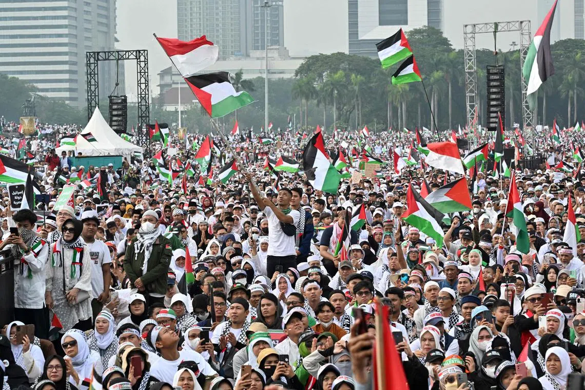 People take part in a mass rally in support of Palestinians in Jakarta on November 5, 2023. Thousands of civilians, both Palestinians and Israelis, have died since October 7, 2023, after Palestinian Hamas militants based in the Gaza Strip entered southern Israel in an unprecedented attack triggering a war declared by Israel on Hamas with retaliatory bombings on Gaza. (Photo by Adek BERRY / AFP)