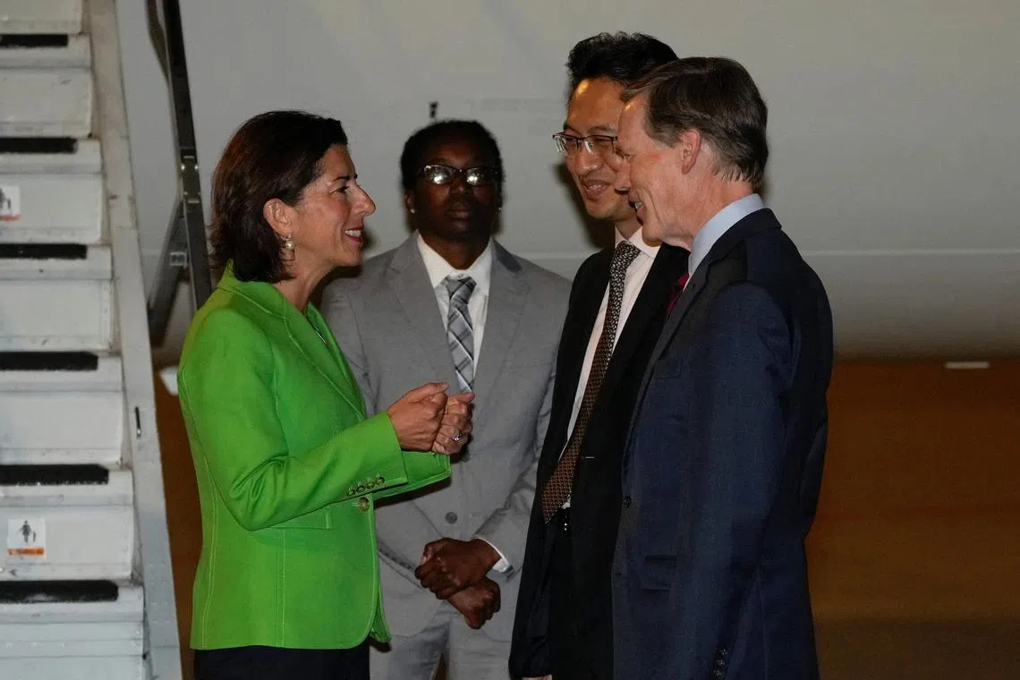 US Commerce Secretary Gina Raimondo is greeted by Chinese Commerce Ministry official Lin Feng upon her arrival in Beijing.