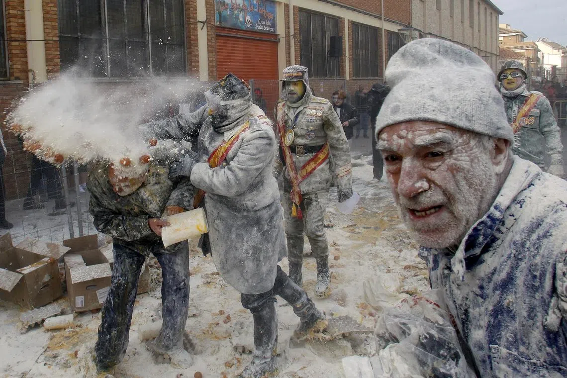 People dressed in miltary costumes taking part in a fake coup d'etat performances during the traditional fest called 'The floured ones' (Els Enfarinats) held in the village of Ibi, Alicante, Spain, Dec 28, 2023. 