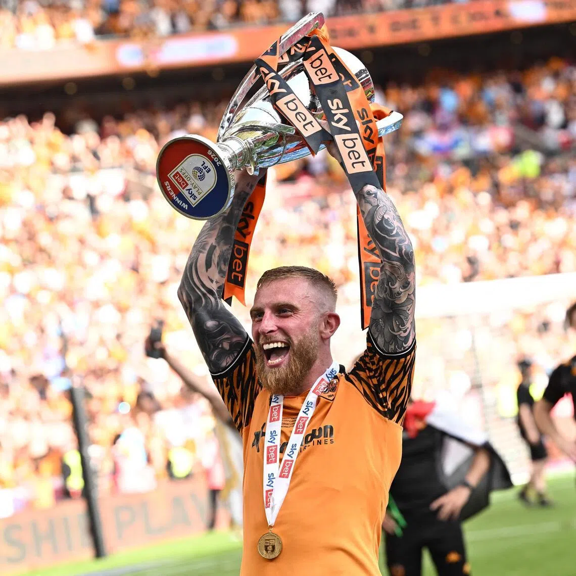 Hull City's Oli McBurnie - who scored the only goal of the match - celebrating with the trophy on May 23, after his team won promotion to the Premier League over Championship rivals Middlesbrough.