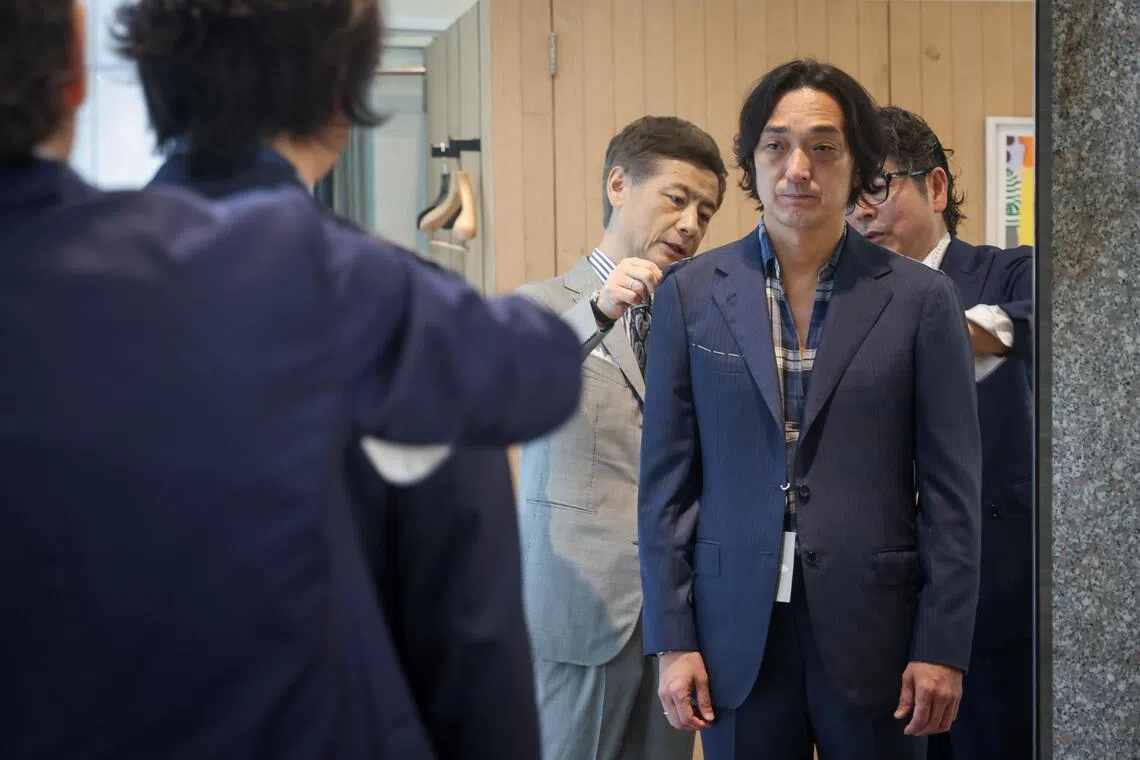 Beams creative director Tatsuya Nakamura (left) and expert fitter Tamao Shirai (right) doing a suit fitting at Colony Clothing.