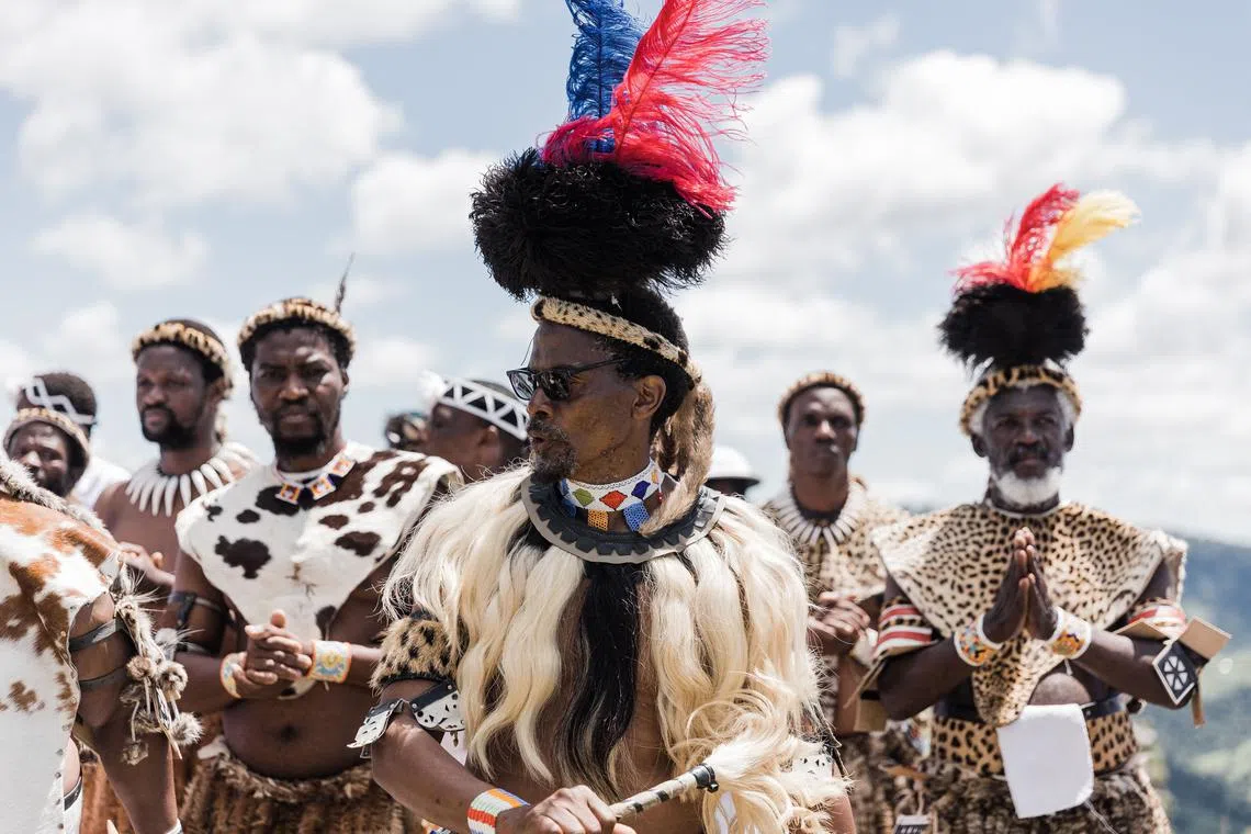Male followers of the Nazareth Baptist Church, from the Ekuphakameni group, also known as the Shembe Church,  gesture during a cultural dance on the Nhlangakazi Holy Mountain in Ndwedwe 85km north of Durban, on Jan 8, 2023. 