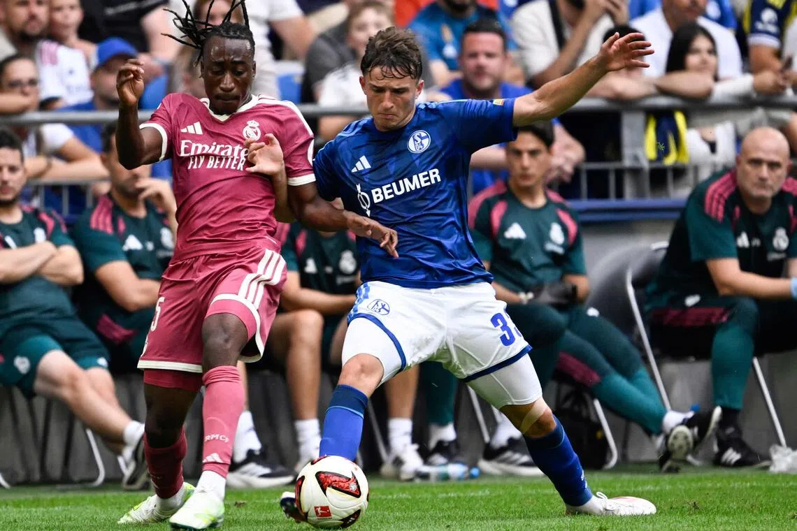 Real Madrid’s Yan Diomande (left) and Schalke’s Vitalie Becker vie for the ball during a friendly football match on Aug 16.