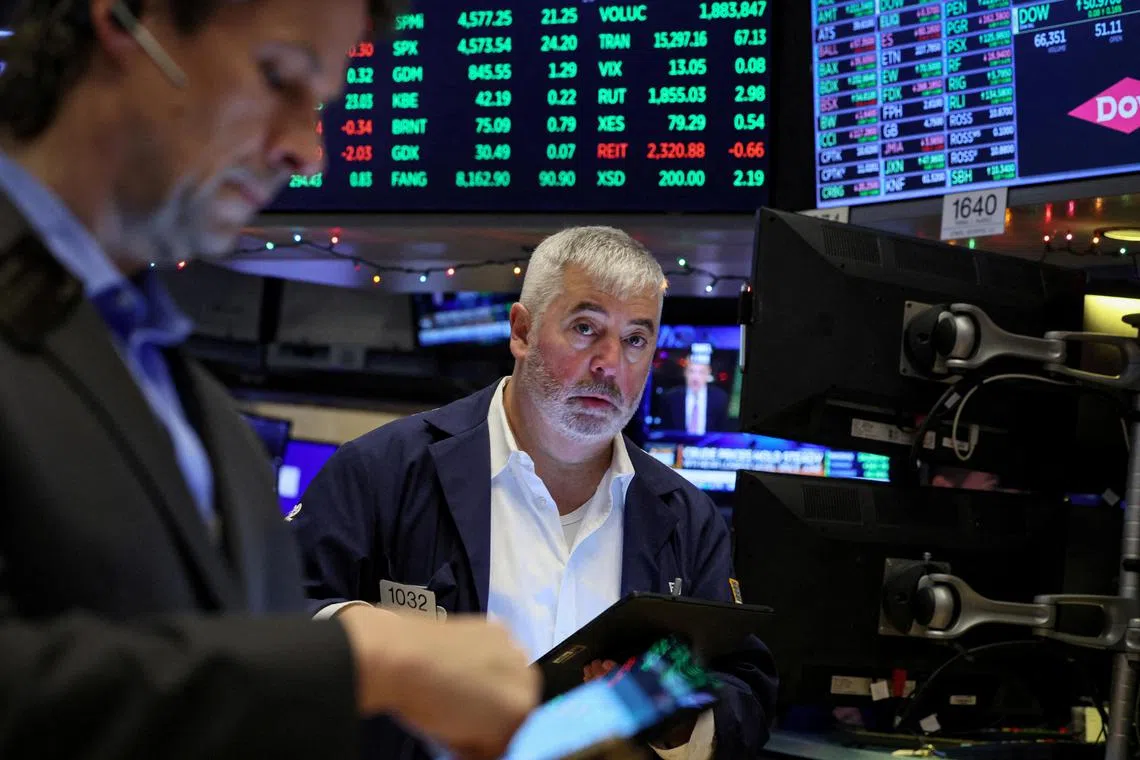 Traders work on the floor at the New York Stock Exchange, in New York City.