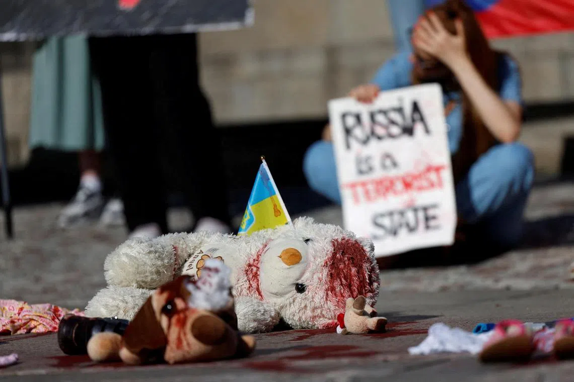 People hold a rally condemning a recent Russian attack on a children's hospital in Kyiv, on July 8.
