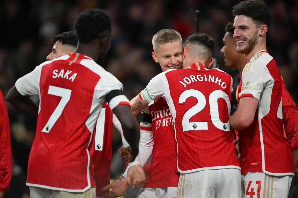Arsenal’s Oleksandr Zinchenko (centre) celebrates scoring their third goal with teammates.