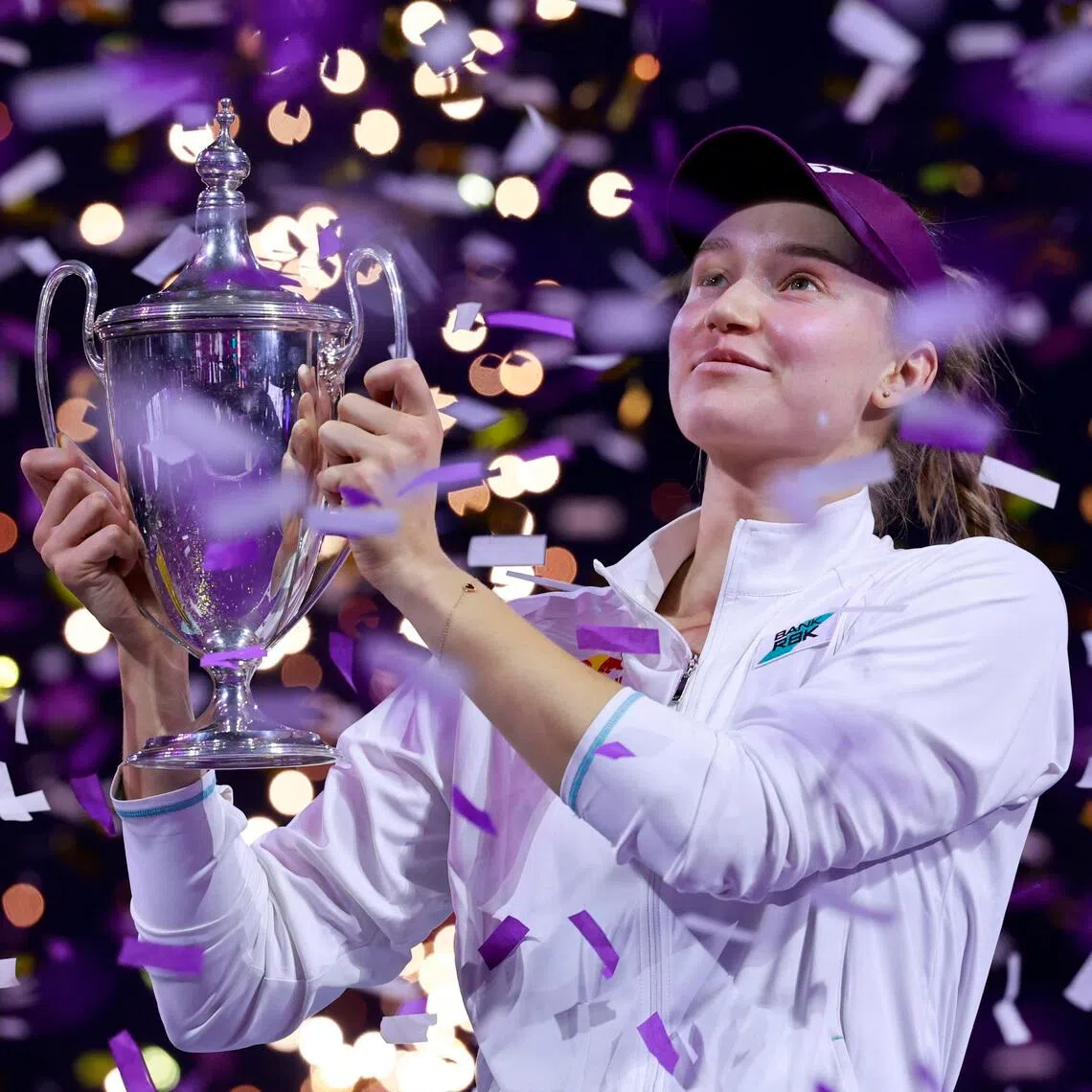 Kazakhstan's Elena Rybakina celebrates with the trophy after beating Belarus' Aryna Sabalenka.