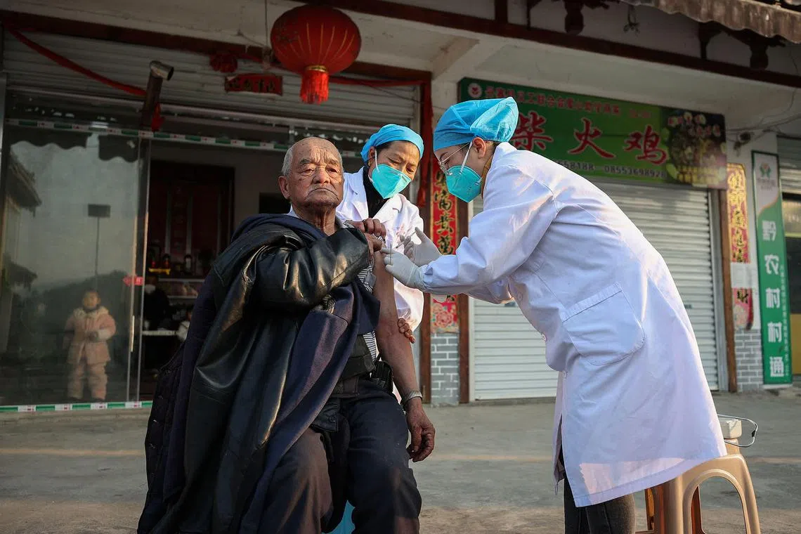 A resident receives a Covid-19 vaccine in Danzhai county in China on Dec 12, 2022.