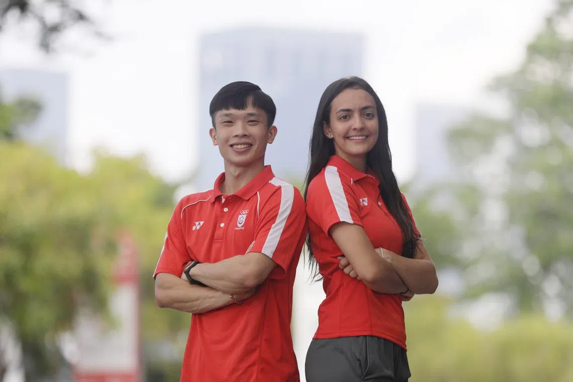 L-R) flagbearers Jowen Lim (wushu) together with Amita Berthier (fencing)