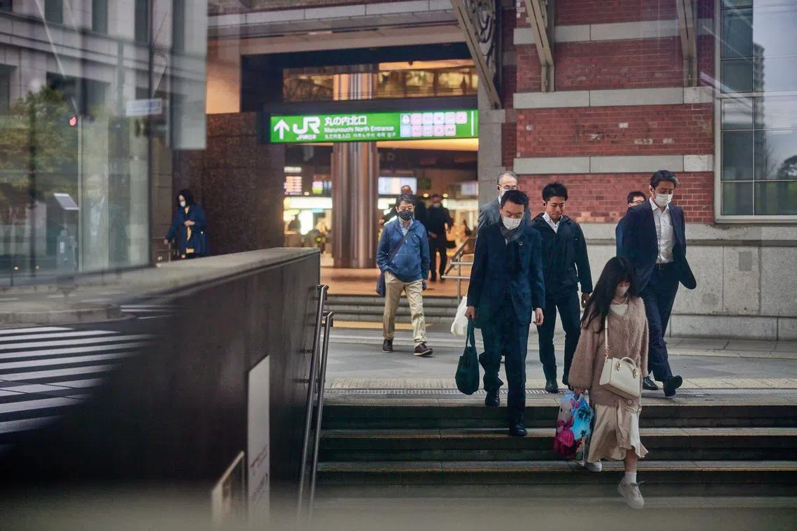 Morning commuters in front of Tokyo Station in Tokyo, Japan, on Thursday, March 30, 2023. The Bank of Japan will release its quarterly Tankan business sentiment survey on April 3. Photographer: Shoko Takayasu/Bloomberg