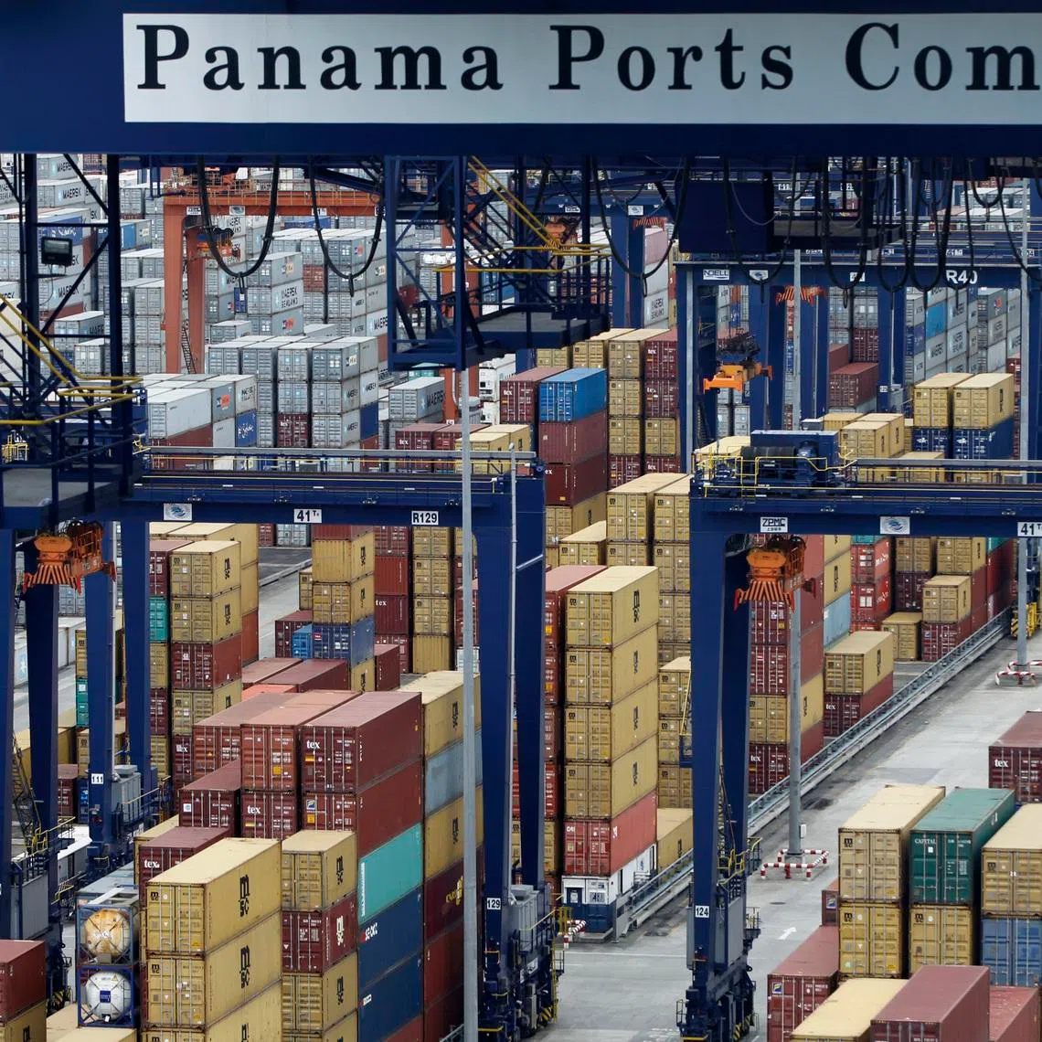 A Panama Ports Company sign is seen over containers at the Balboa port in Panama City October 10, 2014. REUTERS/Carlos Jasso/File Photo