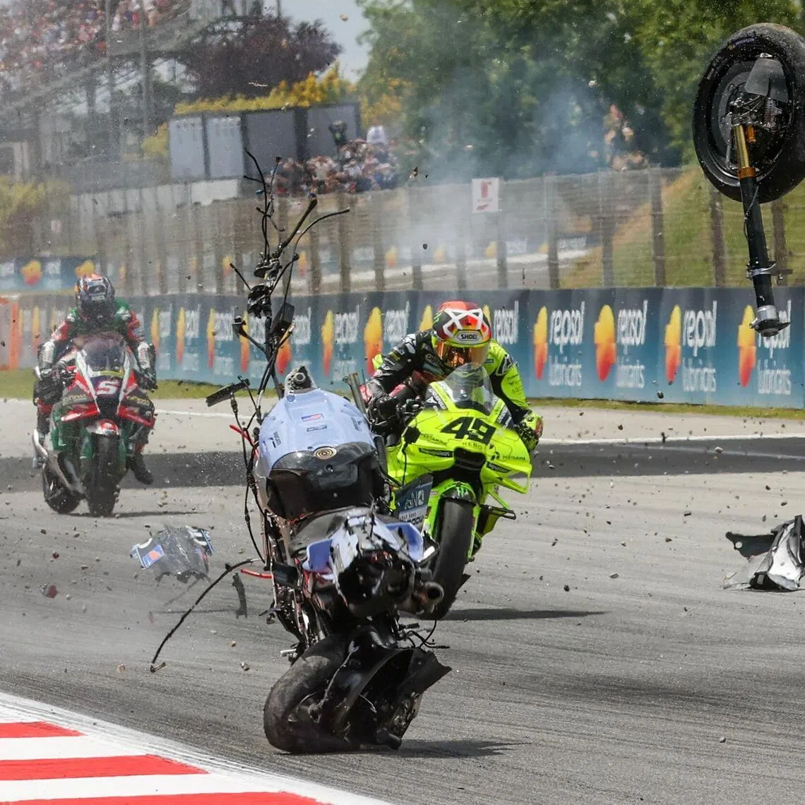 The motorcycle of Team Gresini Racing's Alex Marquez tumbles and breaks apart in front of Team VR46's Fabio di Giannantonio after Marquez crashed during the Catalunya Moto GP Grand Prix in Montmelo, near Barcelona, on May 17, 2026.