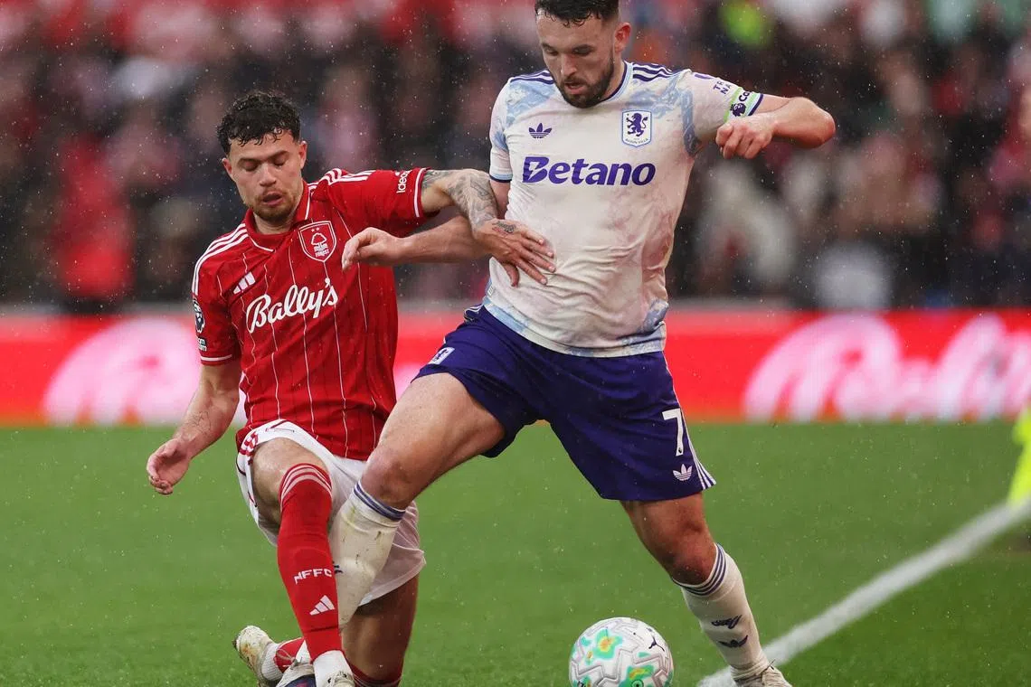 Soccer Football - Premier League - Nottingham Forest v Aston Villa - The City Ground, Nottingham, Britain - April 12, 2026 Aston Villa's John McGinn in action with Nottingham Forest's Neco Williams REUTERS/Chris Radburn