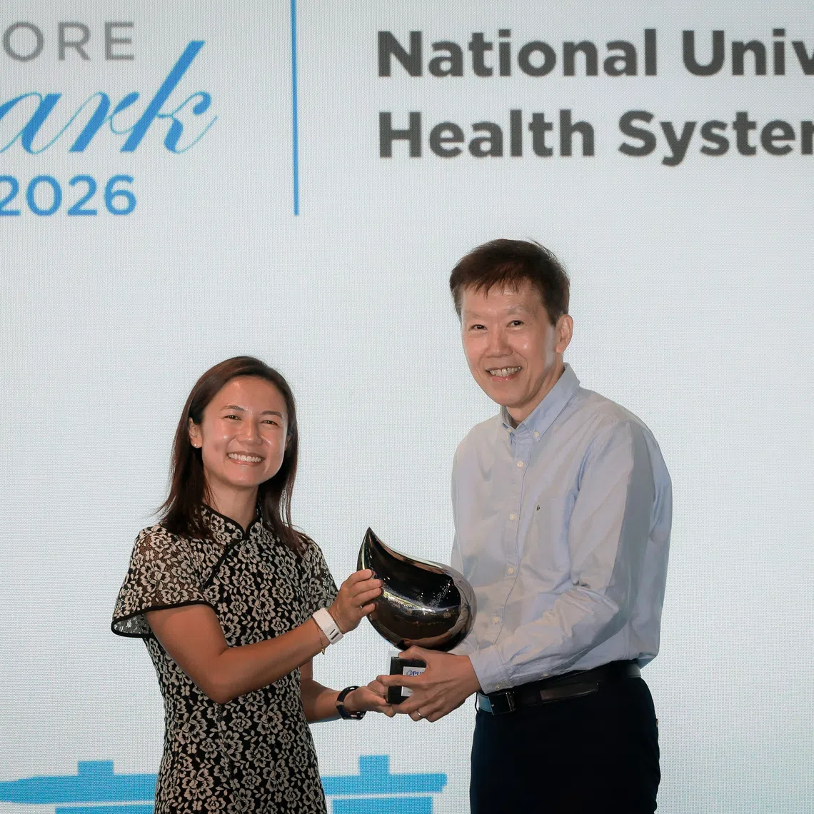 Senior Parliamentary Secretary for the Ministry of Sustainability and the Environment Goh Hanyan (left) presents the Singapore Watermark Award to NUHS Chief Operating Officer Ng Kian Swan at the award ceremony on Sept 25.