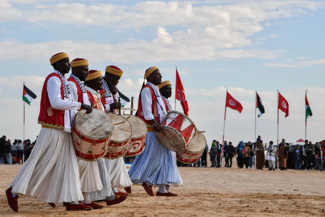 Performers wearing traditional outfits taking part in a show at the start of the International Sahara Festival on Dec 27, 2023 in Douz, in southern Tunisia. 