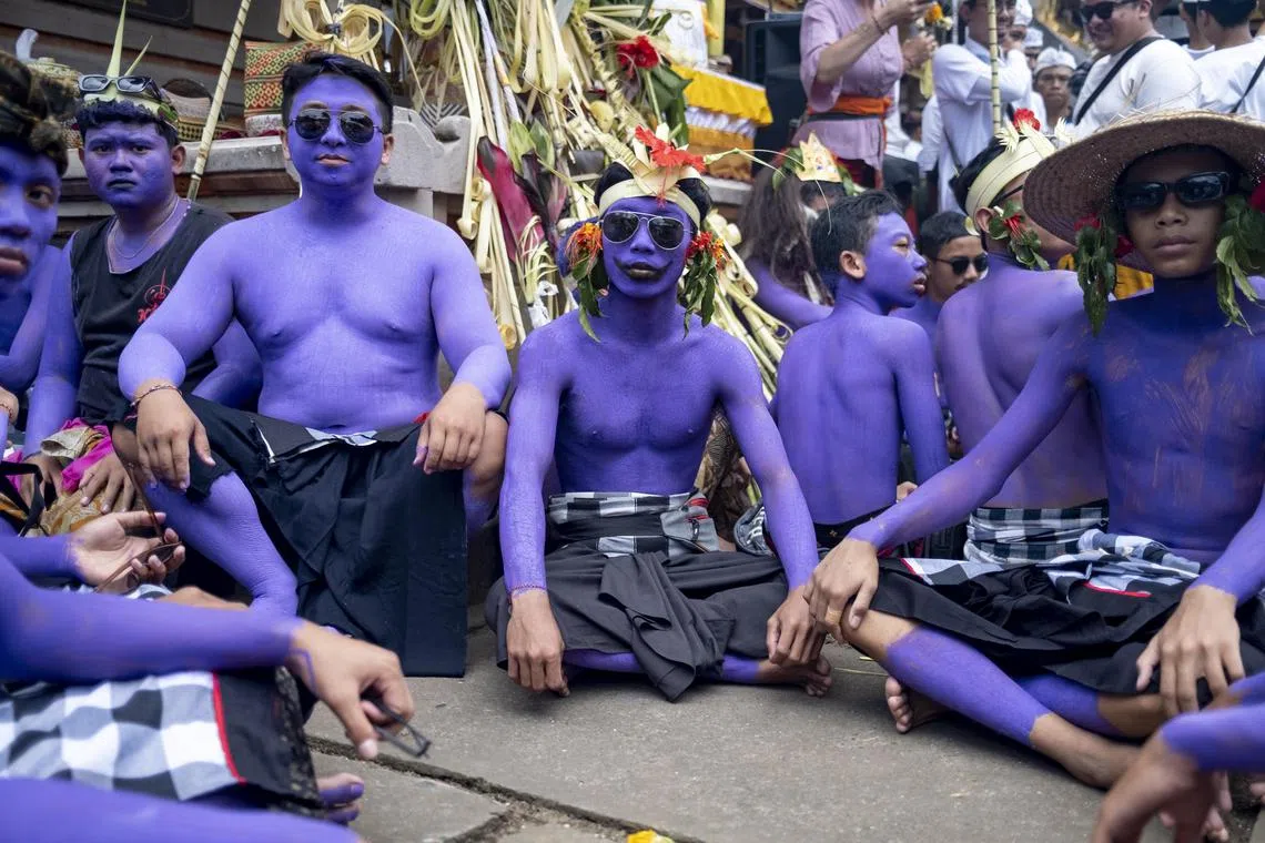 People wear body paint during the sacred Ngerebeg ritual at Tegallalang village in Gianyar, Bali, Indonesia, 08 February 2023. The sacred Ngerebeg ritual takes place every six months and it is mainly aimed at driving all evil spirits out of the villages. During the ritual, participants decorate their body with colorful paint and march across the village.  