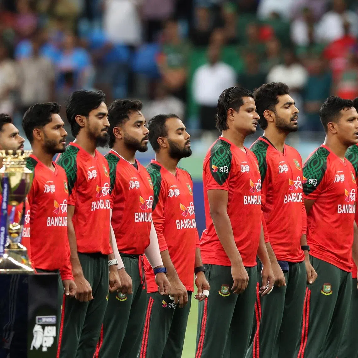Cricket - Asia Cup - India v Bangladesh - Dubai International Cricket Stadium, Dubai, United Arab Emirates - September 24, 2025  General view of the trophy as the Bangladesh players line up during the national anthems before the match REUTERS/Satish Kumar