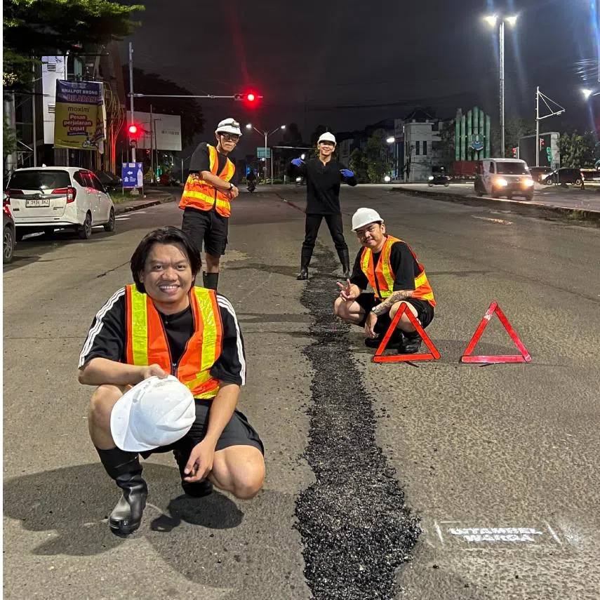 In Indonesia, members of community group Gen Burgeract fill in a pothole in Bekasi, West Java, in the early hours of March 7.