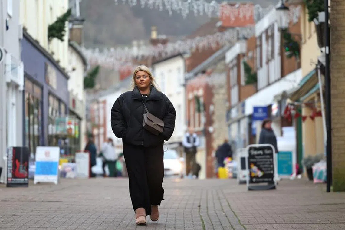 Rebecca Kaya walks through the town centre, following an interview with Reuters, in Dursley, south west Britain, December 18, 2023. REUTERS/Toby Melville