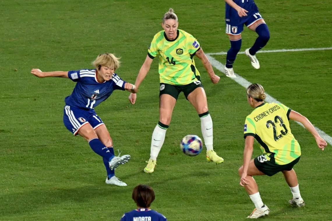 Japan's Maika Hamano (left) shoots and scores the winning goal during the final of the AFC Women’s Asian Cup.