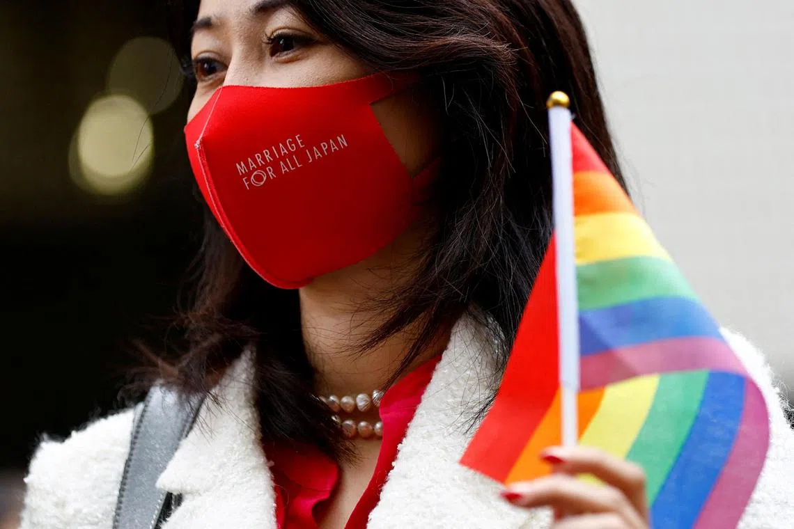 FILE PHOTO: The lawyer of the plaintiffs holds a rainbow flag outside the court after hearing the ruling on same-sex marriage, in Tokyo, Japan, November 30, 2022. REUTERS/Kim Kyung-Hoon/File Photo