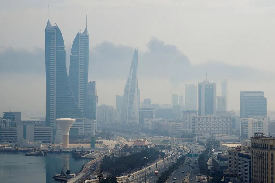 Smoke rises following a reported Iranian drone strike on the fuel storage facility of Bahrain International Airport, amid the U.S.-Israeli conflict with Iran, in Muharraq, Manama, Bahrain, March 12, 2026. REUTERS/Stringer