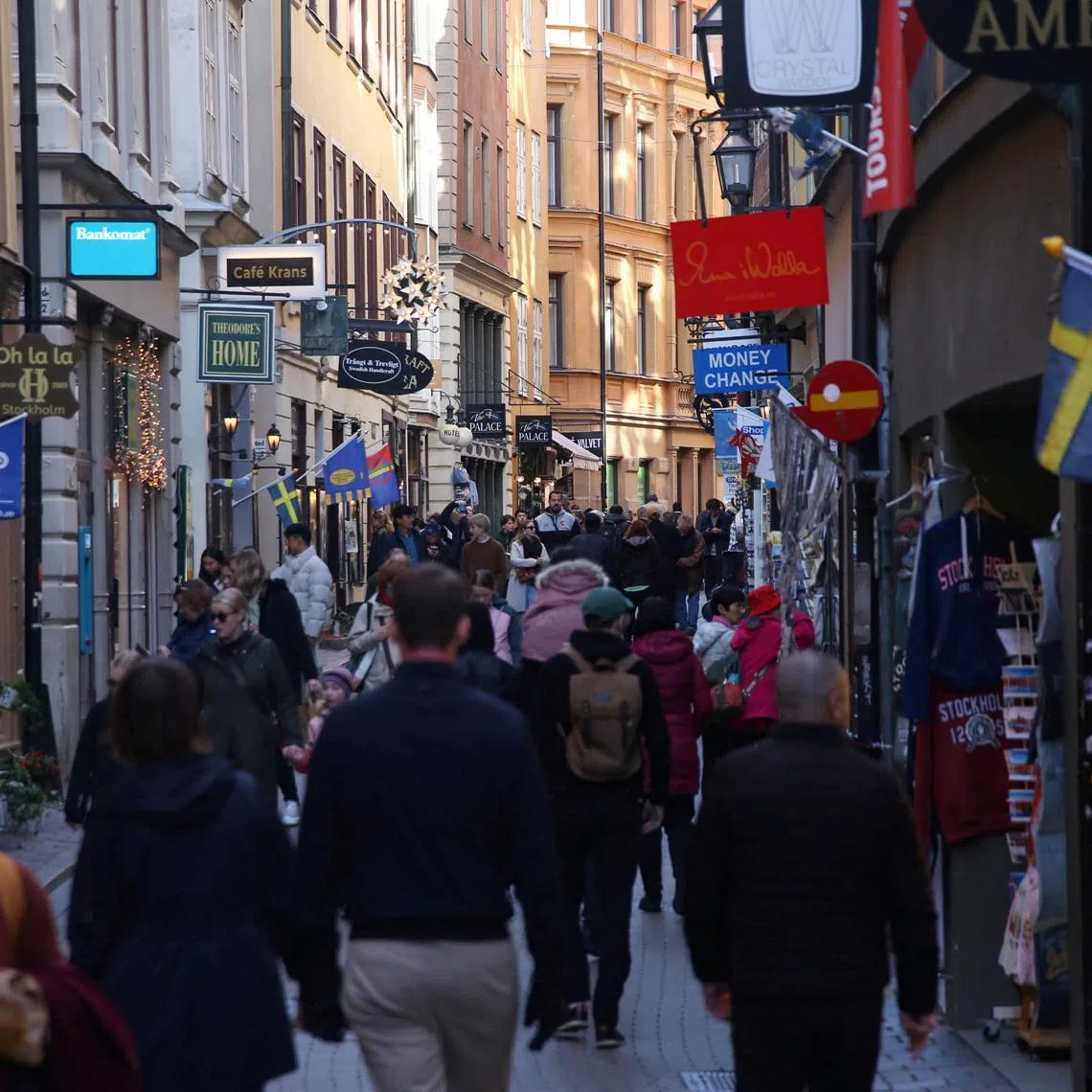 Pedestrians walk along a street in the Old Town of Stockholm, Sweden, October 17, 2024. REUTERS/ Tom Little/File Photo