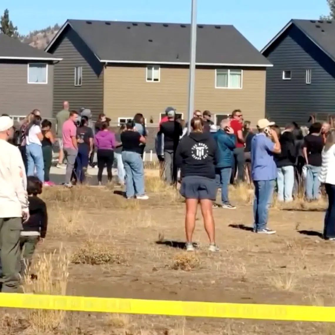 People stand near the scene of a shooting at Silver Rail Elementary School in Bend, Oregon, US, October 15, 2026, in this screengrab from a handout video.     ABC affiliate KOHD/Handout via REUTERS