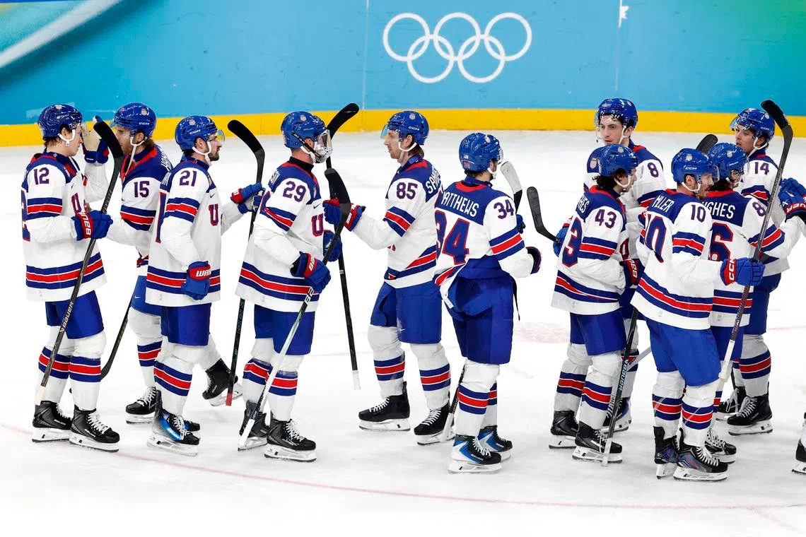 Milano Cortina 2026 Olympics - Ice Hockey - Men's Play-offs Semifinals - United States vs Slovakia - Milano Santagiulia Ice Hockey Arena, Milan, Italy - February 20, 2026. Jake Sanderson of United States with teammates celebrate after the match REUTERS/David W Cerny