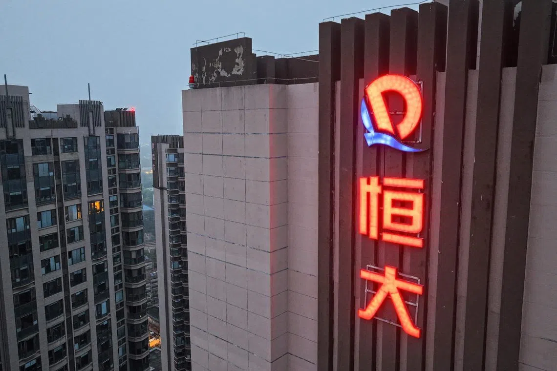 The logo of China Evergrande Group on an apartment buildings in Nanjing, China.  Evergrande’s delisting on Aug 25, 2025, closes a chapter, but China property debt crisis drags on.