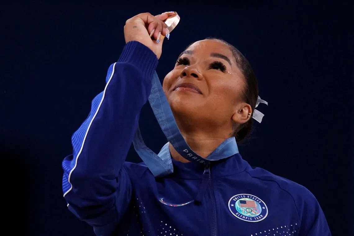 Jordan Chiles looks at her bronze medal at the Paris Olympics. She has since been stripped of third place but USA Gymnastics is doing all it can to make sure she retains her medal.