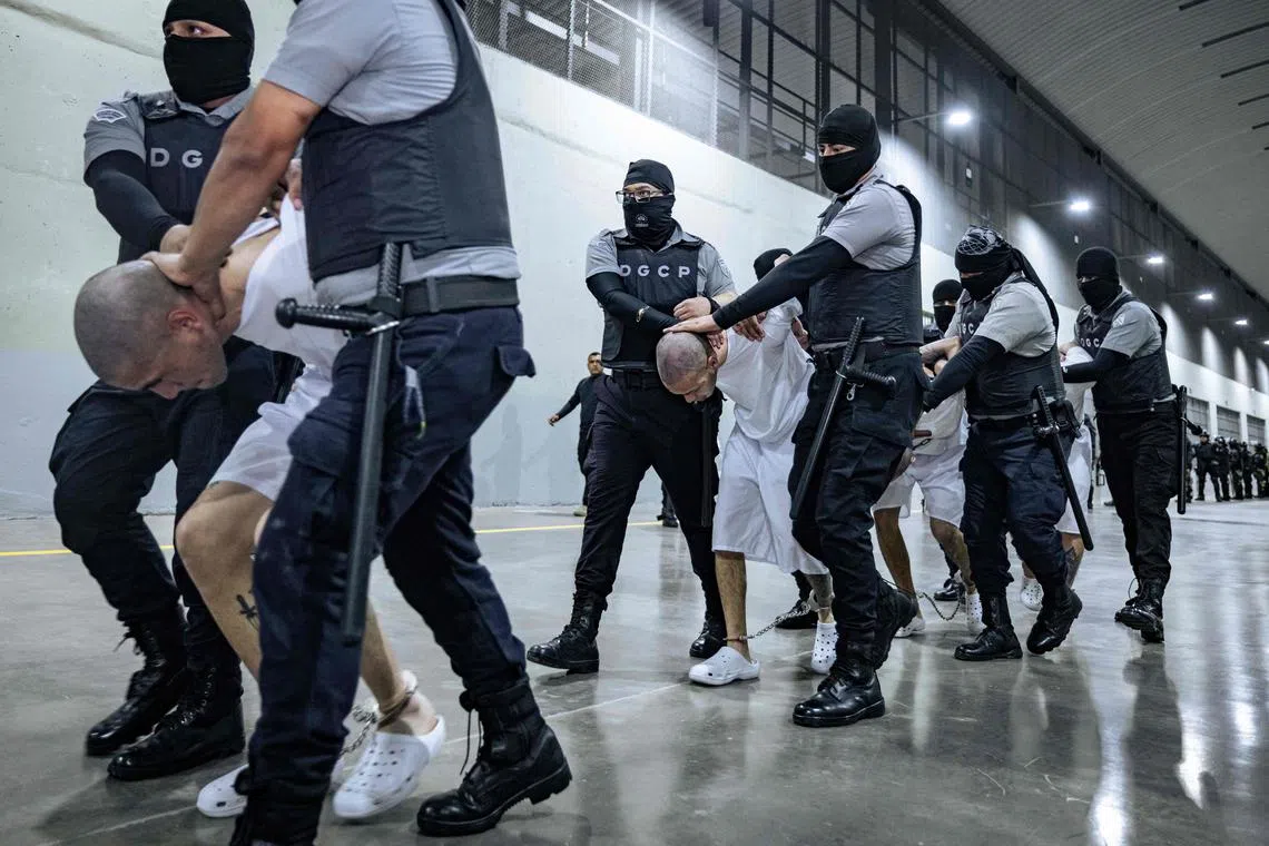 Alleged Tren de Aragua and MS-13 gang members arriving in El Salvador, in a photo release by El Salvador on March 31.