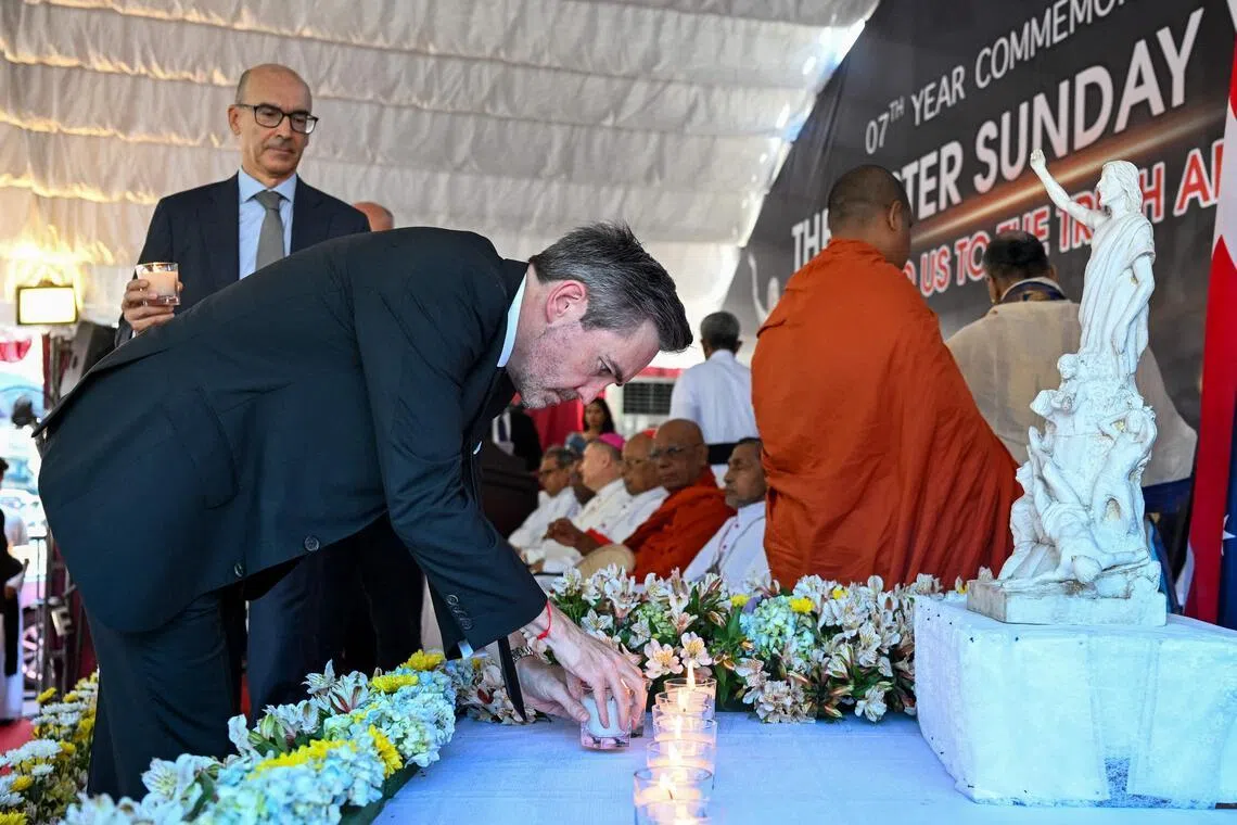 United Nations resident coordinator in Sri Lanka, Mr Marc-André Franche (centre) places candles as he pays homage to the victims of 2019 Easter Sunday bombings at the St. Anthony's Church in Colombo on April 21, 2026. 