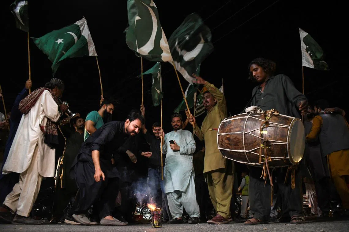 People celebrate after the ceasefire announcement between India and Pakistan, in Hyderabad, Pakistan, May 10, 2025. REUTERS/Yasir Rajput