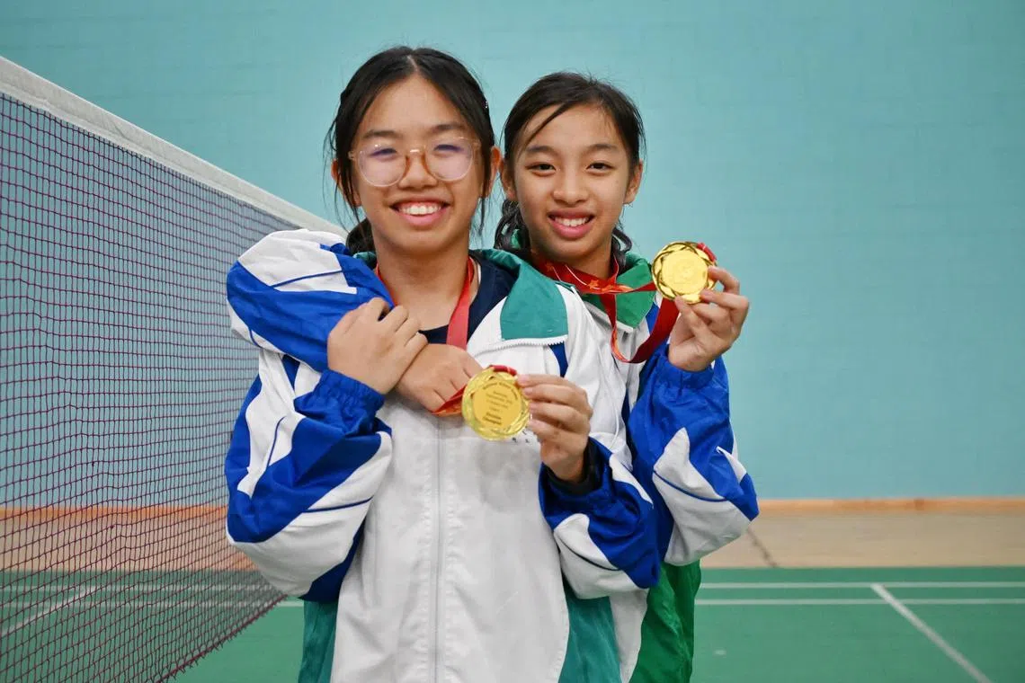 Sisters Emma (right) and Ellie Ang of CHIJ St Nicholas Girls' School celebrating their win at the National School Games C Division girls final at the OCBC Arena, on Aug 27, 2025.