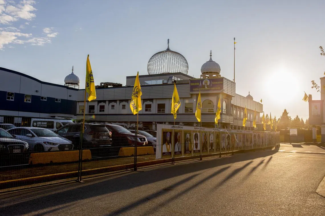 FILE — Flags of the Khalistan separatist movement flank the Guru Nanak Sikh Gurdwara, where Hardeep Singh Nijjar was shot and killed in the parking lot in June, in Surrey, British Columbia, Canada, on Sept. 20, 2023. Prime Minister Justin Trudeau’s top aides spoke at a public hearing a day after Canada accused Indian diplomats of orchestrating killings and extortions in the country. (Jackie Dives /The New York Times)