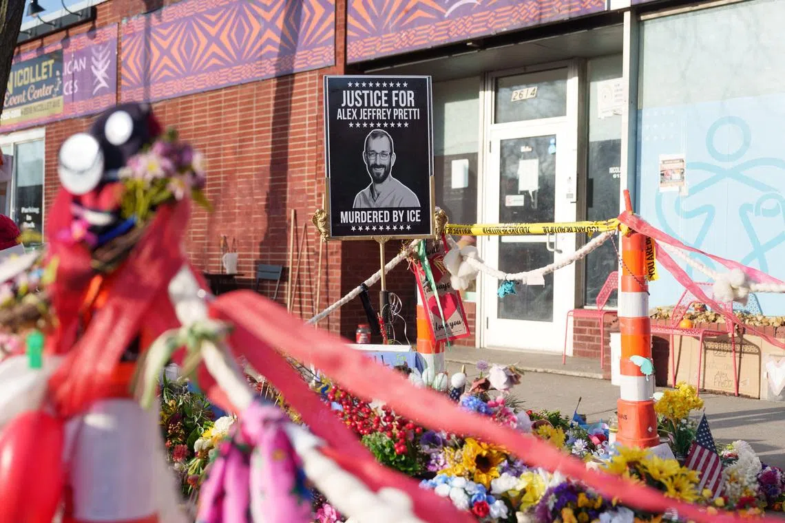 A sign showing Alex Pretti at a memorial in Minneapolis, Minnesota, U.S., March 12, 2026. REUTERS/Tim Evans