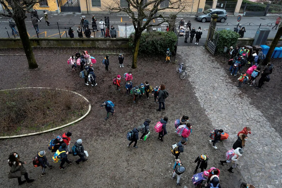 Primary schoolchildren stand in groups in a school courtyard in Maleo, Italy, January 7, 2021. REUTERS/Marzio Toniolo/File Photo