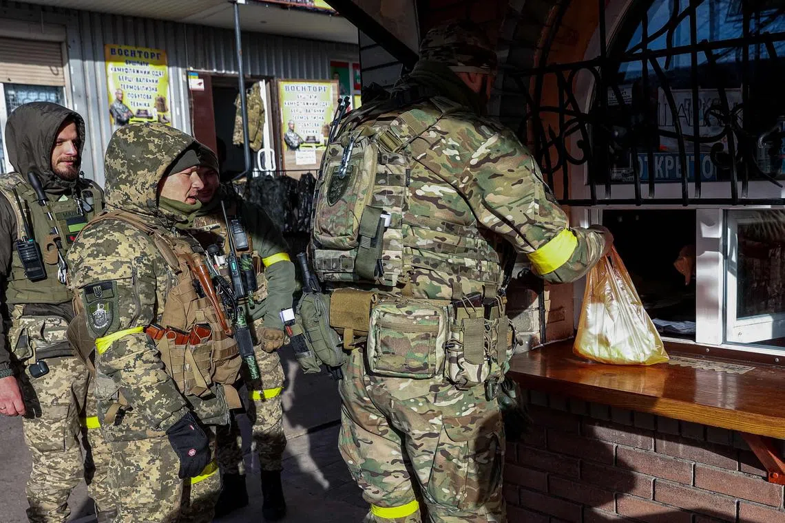Ukrainian soldiers buy food in Kostyantynivka, eastern Ukraine on Dec 1, 2022.